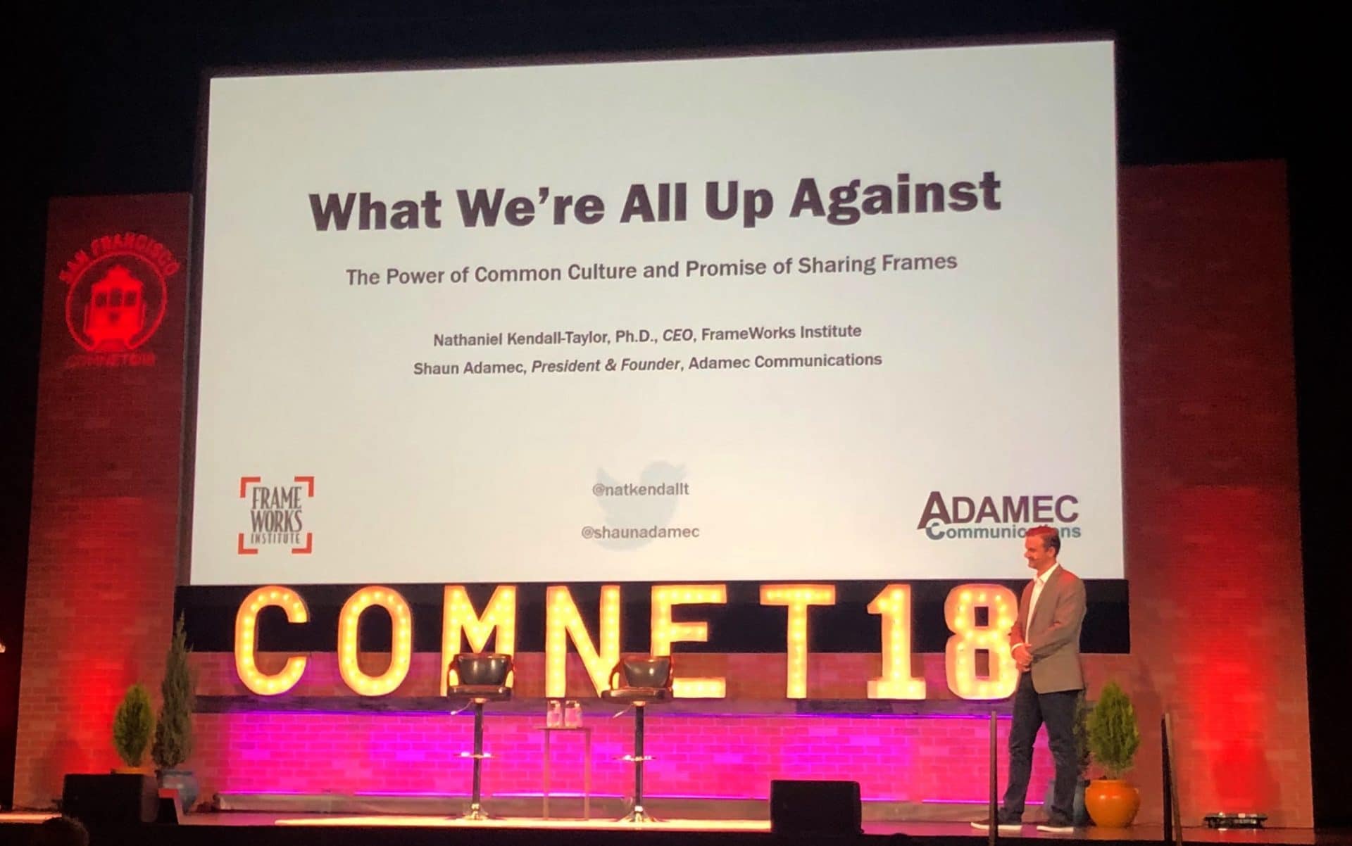 man giving a presentation on theater stage at ComNet18